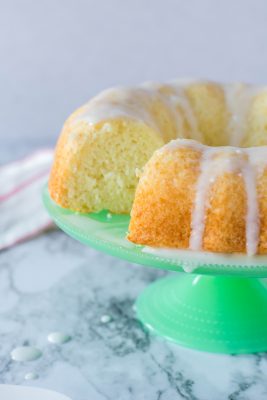 Mountain dew bundt cake on a green pedestal with a simple glaze.