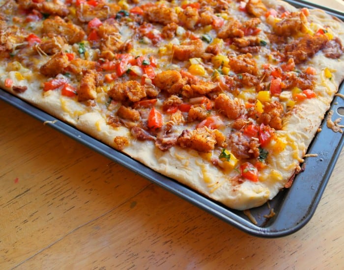 This Mexican Pizza comes together quickly with diced Tyson chicken strips, pizza dough, cheese, refried beans for topping and taco sauce.  Kid approved! - Farmers Wife Rambles