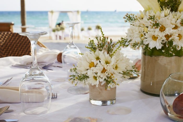 Keeping the centerpieces simple and low allow guests to still enjoy each others company during your next dinner party or big event!