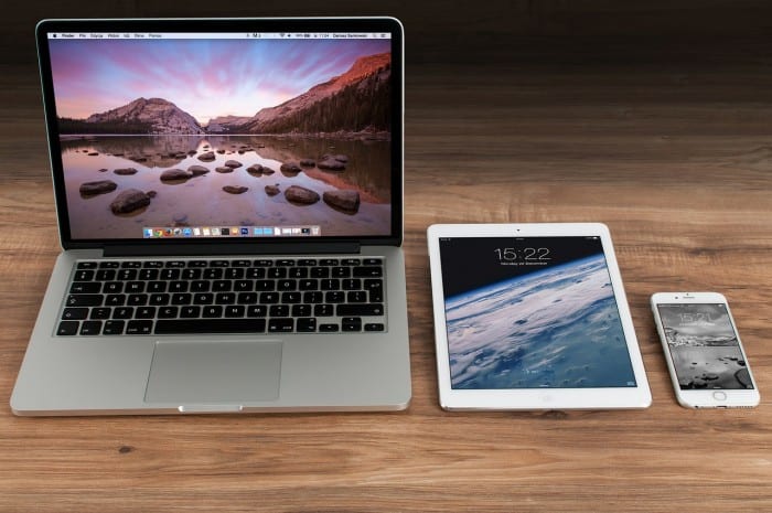 3 electronics on a table and showing why a power strip can lower utility bills